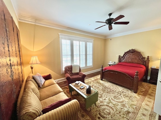 bedroom with baseboards, ornamental molding, ceiling fan, and wood finished floors