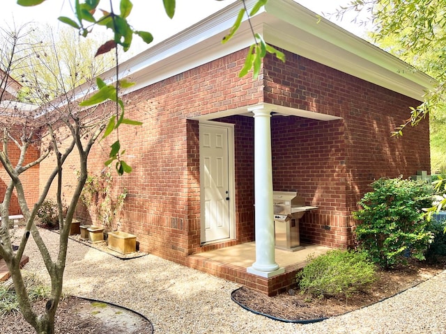 view of exterior entry with brick siding