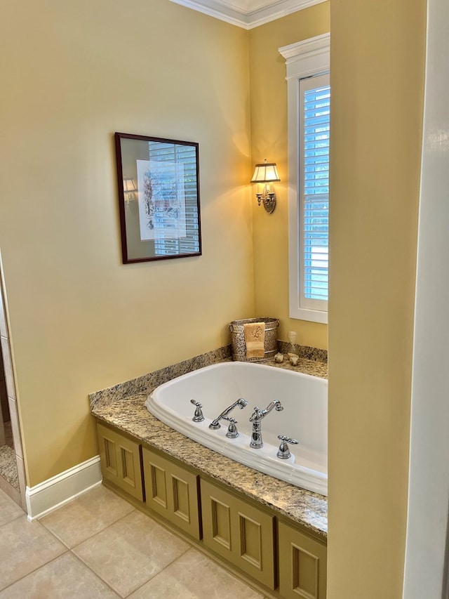 bathroom with ornamental molding, tile patterned flooring, a bath, and baseboards