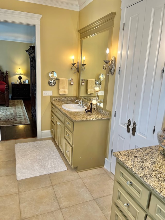 ensuite bathroom with tile patterned flooring, connected bathroom, crown molding, and vanity