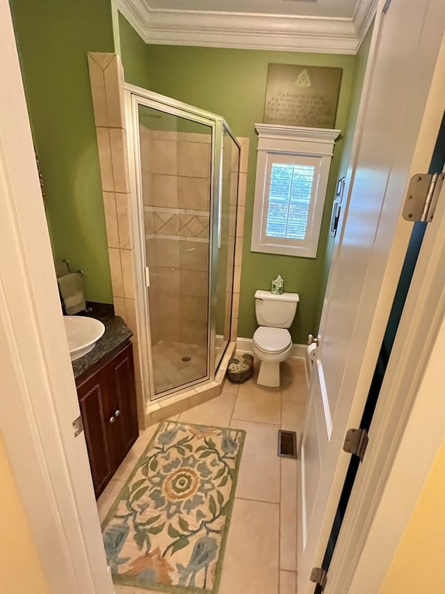 full bath with toilet, a stall shower, crown molding, and tile patterned floors