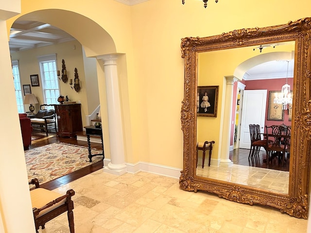 corridor featuring arched walkways, ornate columns, ornamental molding, coffered ceiling, and baseboards