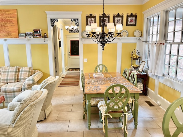 dining room featuring a chandelier, visible vents, ornamental molding, and light tile patterned floors