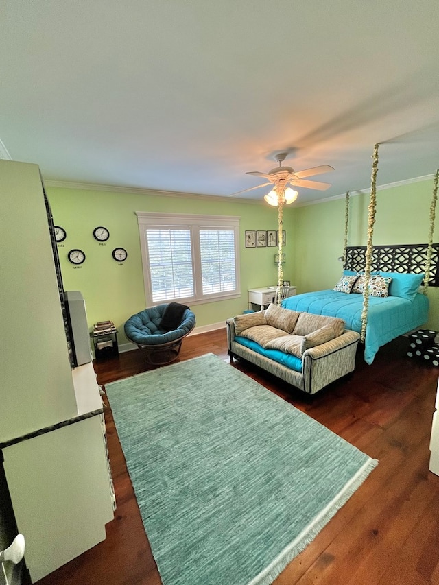 bedroom featuring baseboards, ceiling fan, dark wood finished floors, and crown molding