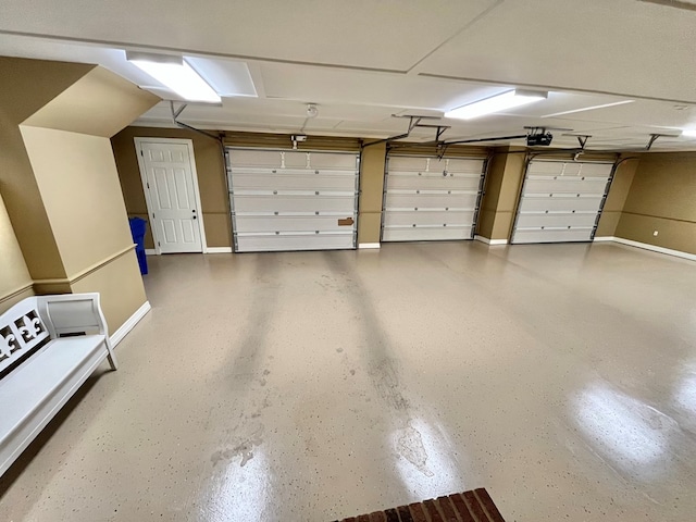 garage featuring baseboards and a garage door opener