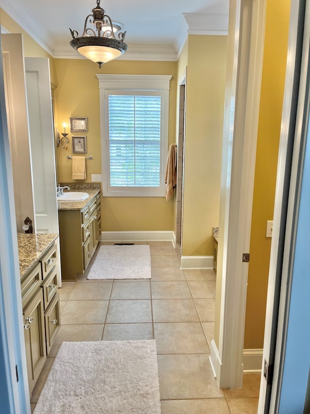 full bath featuring tile patterned flooring, crown molding, vanity, and baseboards