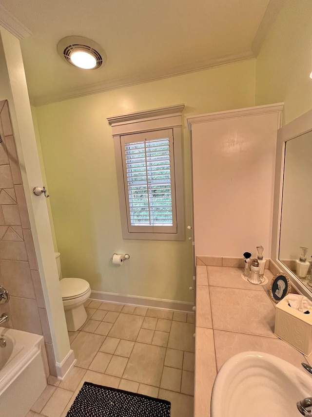 full bathroom featuring toilet, a sink, baseboards, tile patterned floors, and crown molding