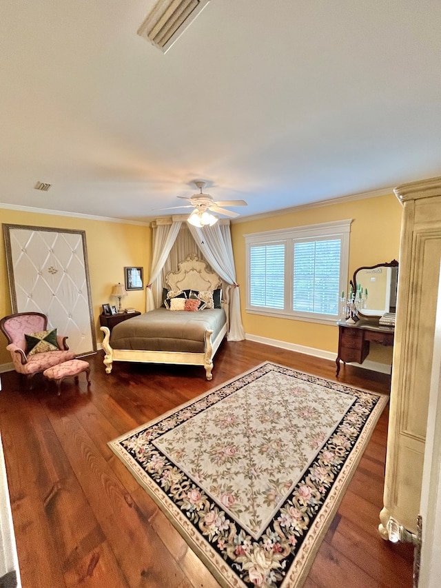 bedroom with ornamental molding, ceiling fan, baseboards, and wood finished floors