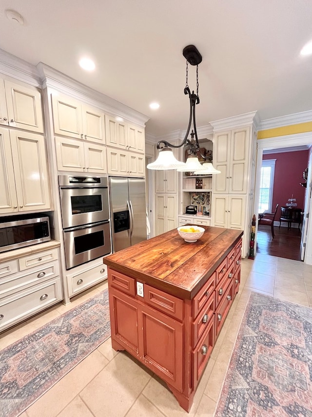 kitchen with light tile patterned flooring, crown molding, wooden counters, appliances with stainless steel finishes, and pendant lighting