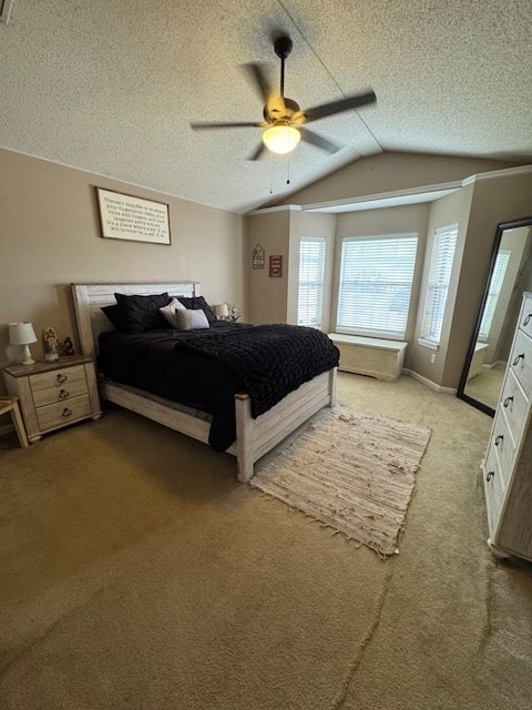 carpeted bedroom with vaulted ceiling, ceiling fan, and a textured ceiling