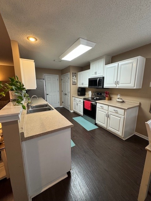 kitchen with sink, white cabinetry, kitchen peninsula, and appliances with stainless steel finishes