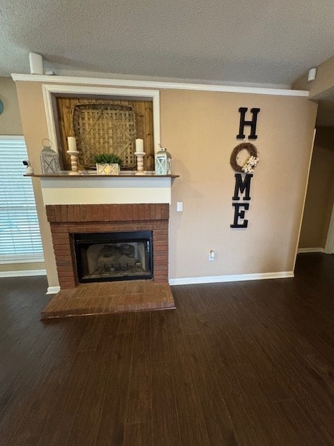 unfurnished living room featuring dark hardwood / wood-style flooring, a textured ceiling, and a brick fireplace