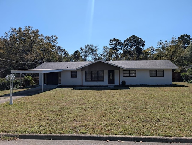 ranch-style home with a front yard and a carport