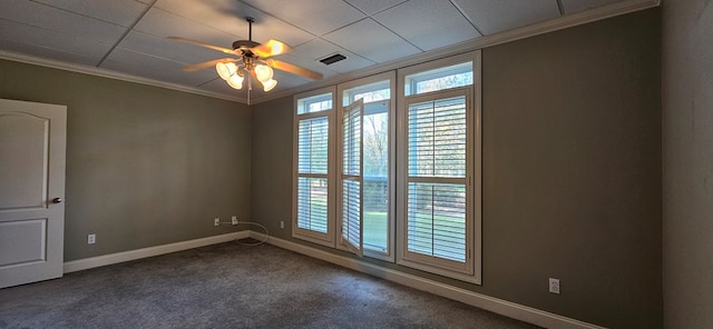 empty room featuring visible vents, dark carpet, crown molding, baseboards, and ceiling fan