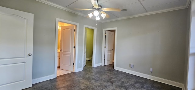 unfurnished bedroom featuring connected bathroom, crown molding, and baseboards