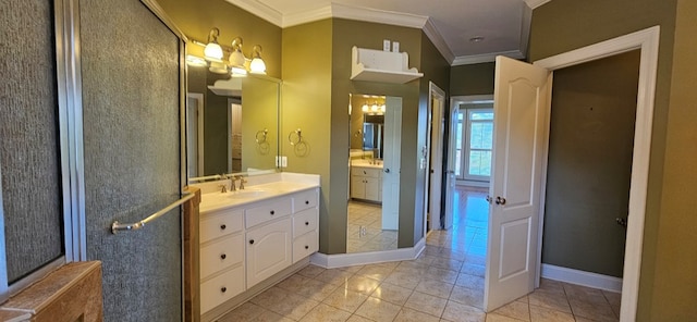 bathroom featuring tile patterned flooring, vanity, baseboards, and ornamental molding