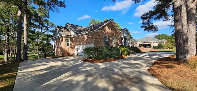 view of home's exterior featuring brick siding, concrete driveway, and a garage