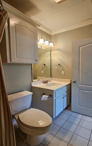 bathroom with tile patterned floors, vanity, toilet, and crown molding