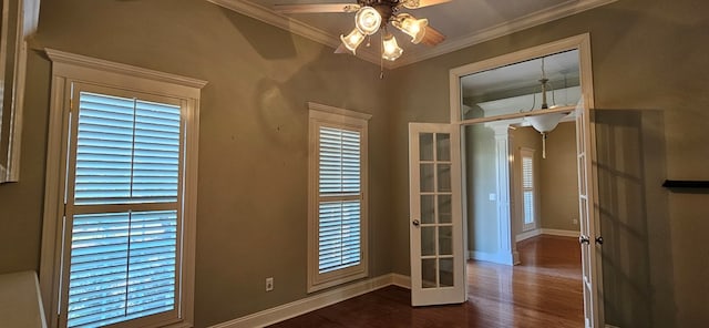 interior space featuring dark wood finished floors, french doors, crown molding, baseboards, and ceiling fan