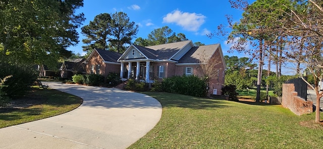 neoclassical / greek revival house featuring brick siding, concrete driveway, and a front lawn