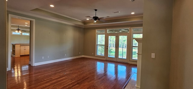 unfurnished room featuring plenty of natural light, a raised ceiling, baseboards, and dark wood-style flooring