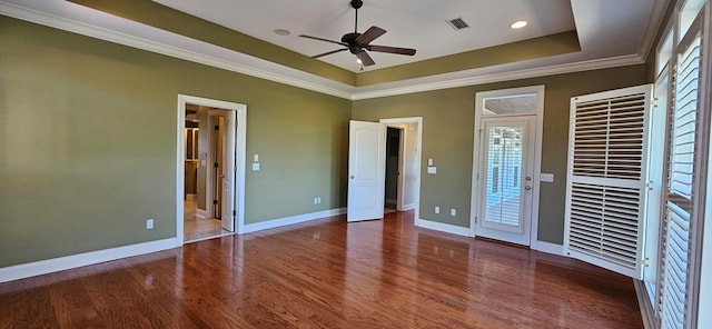 unfurnished bedroom featuring a raised ceiling, access to outside, wood finished floors, and visible vents