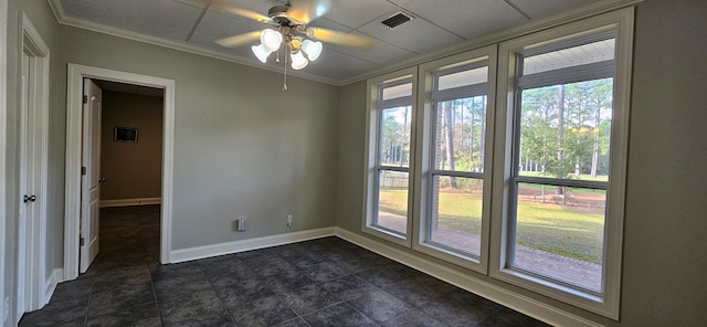 empty room with visible vents, crown molding, ceiling fan, baseboards, and a drop ceiling