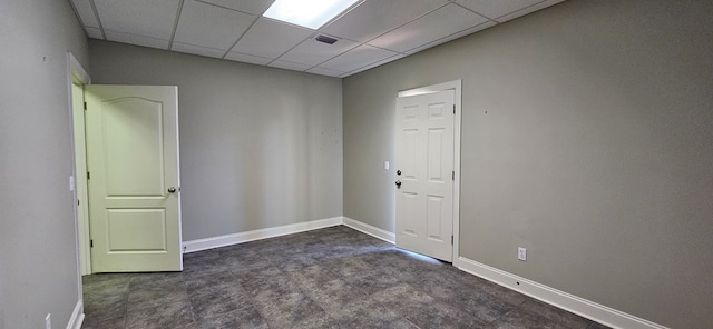 spare room with a drop ceiling, baseboards, and visible vents