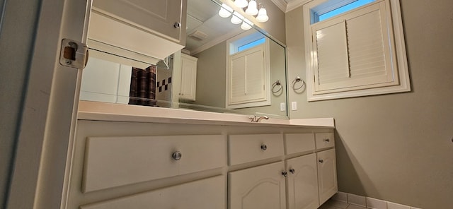 bathroom with vanity, baseboards, and ornamental molding