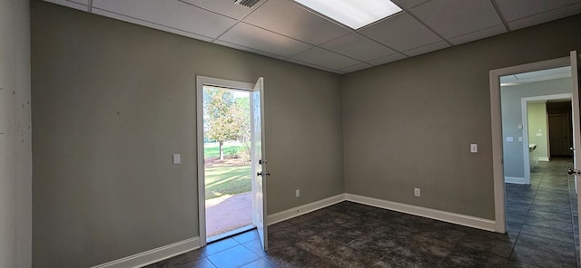 entryway with dark tile patterned floors, a drop ceiling, visible vents, and baseboards