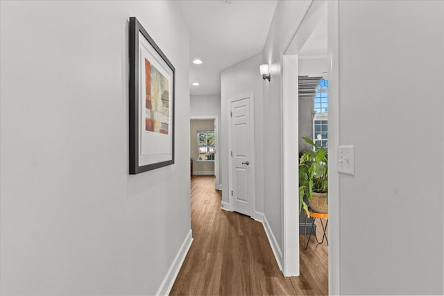 hallway with dark wood-style floors, recessed lighting, and baseboards