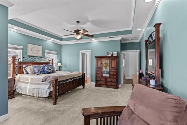 bedroom featuring light carpet, baseboards, a tray ceiling, and ornamental molding