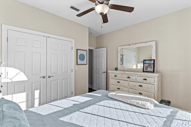 bedroom with a closet, visible vents, and ceiling fan