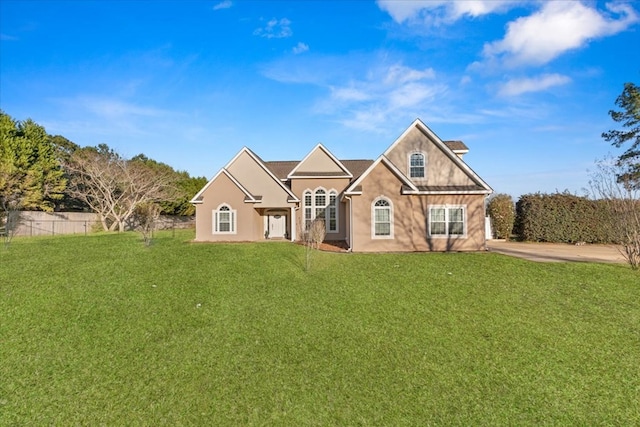 view of front of house with fence and a front yard