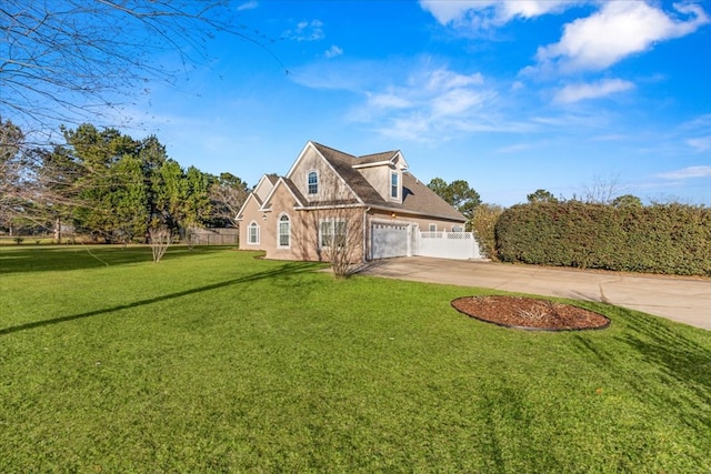 view of front of home with concrete driveway, a front lawn, an attached garage, and fence