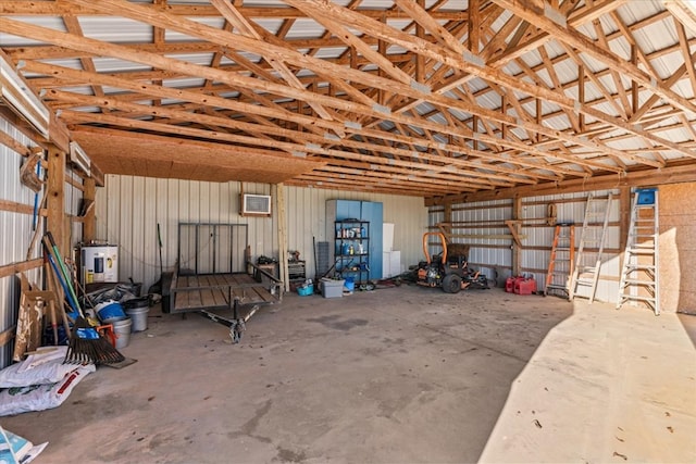 garage with water heater and metal wall