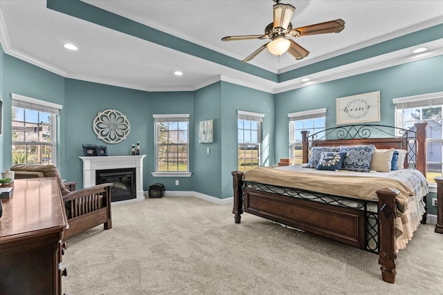 bedroom featuring light carpet, baseboards, a glass covered fireplace, ornamental molding, and recessed lighting