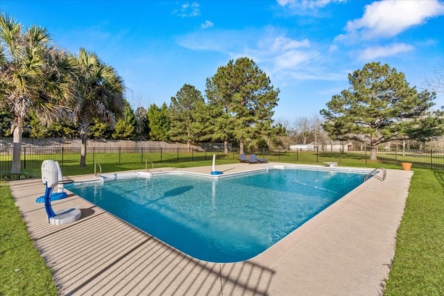 view of swimming pool featuring a lawn, fence, and a fenced in pool