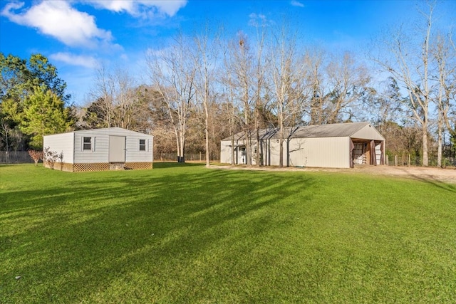 view of yard featuring driveway, an outbuilding, and an outdoor structure