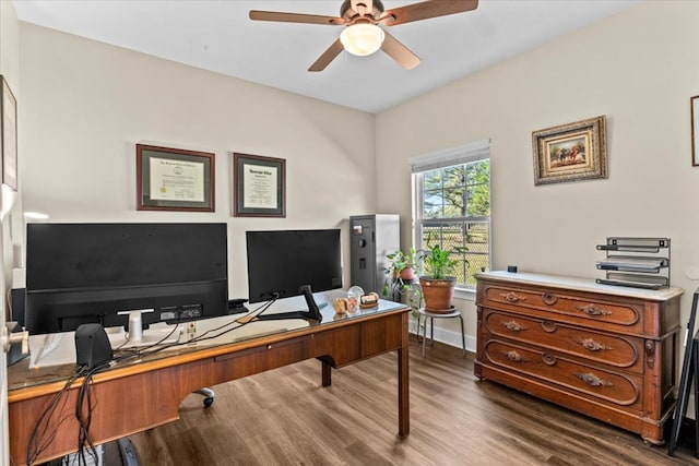 office area featuring dark wood-style floors, a ceiling fan, and baseboards