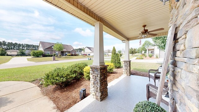 view of patio with a porch, a residential view, and a ceiling fan