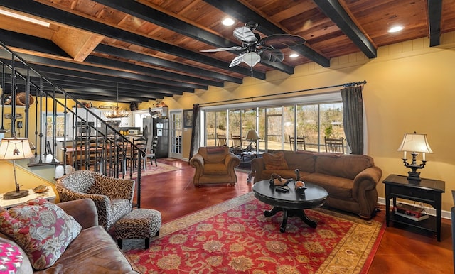 living room with beamed ceiling, ceiling fan, wooden ceiling, and dark tile patterned flooring