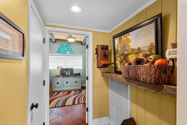 corridor with tile patterned flooring and crown molding