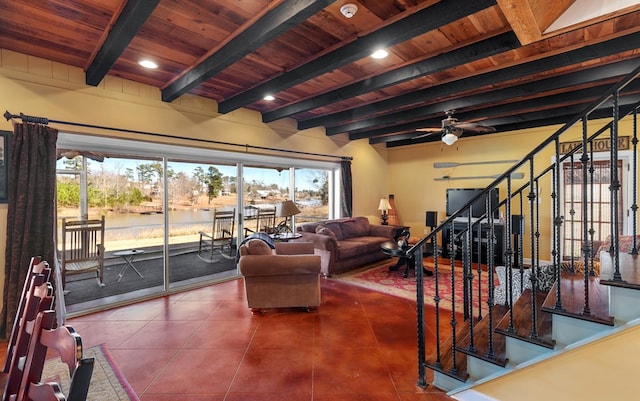 living room featuring ceiling fan, tile patterned flooring, beamed ceiling, a water view, and wood ceiling