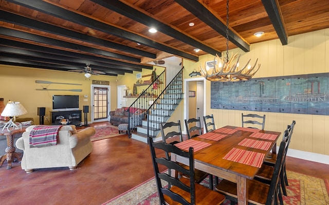 dining room featuring beamed ceiling, ceiling fan with notable chandelier, and wood ceiling