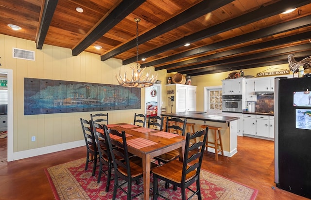 dining area with beam ceiling, an inviting chandelier, and wood ceiling