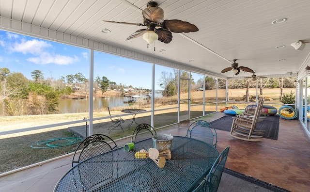 exterior space with a water view and ceiling fan