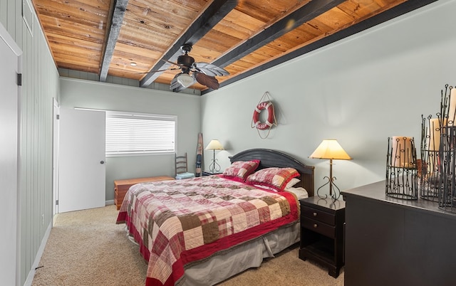 bedroom featuring beamed ceiling, light carpet, ceiling fan, and wooden ceiling