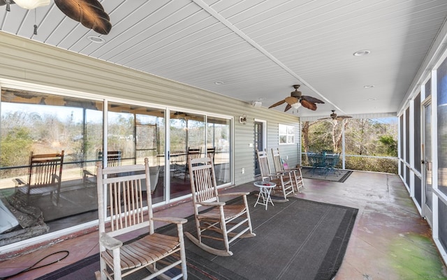 sunroom / solarium featuring ceiling fan and vaulted ceiling