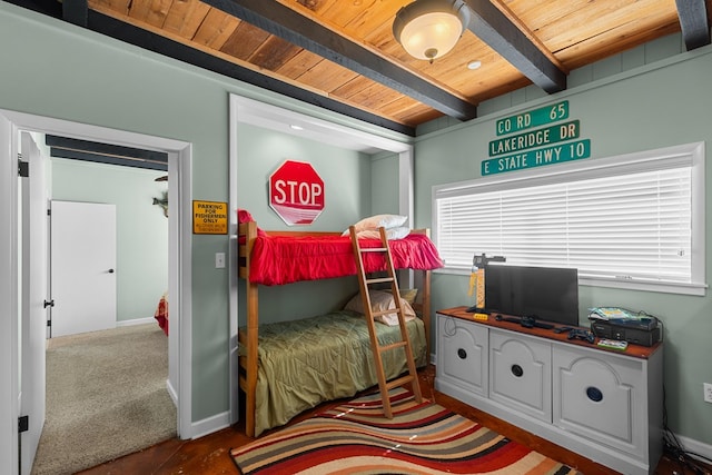 carpeted bedroom with beamed ceiling, wood ceiling, and multiple windows